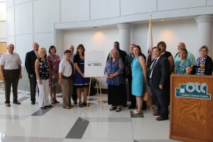 Members of the Adams County Works teams pose for a photo with the new logo.